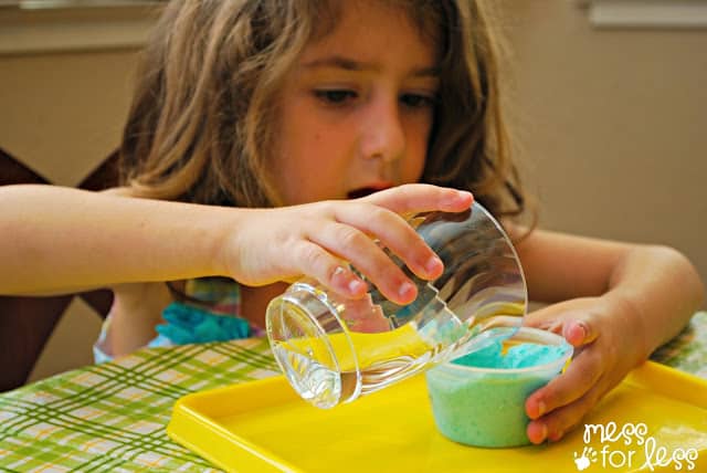 Pouring vinegar on lotion dough