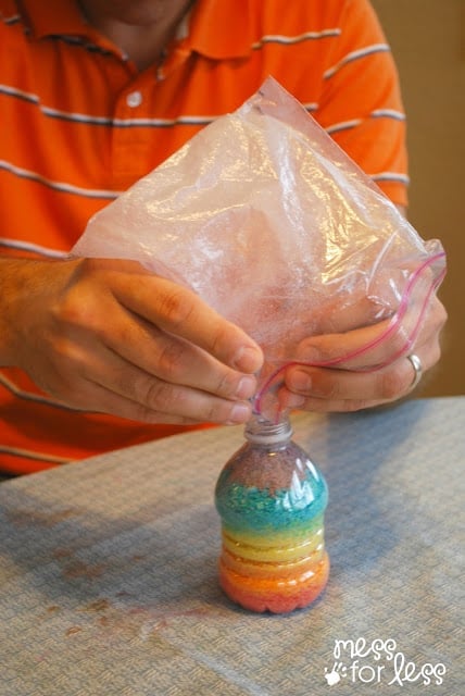 pouring sand into a bottle