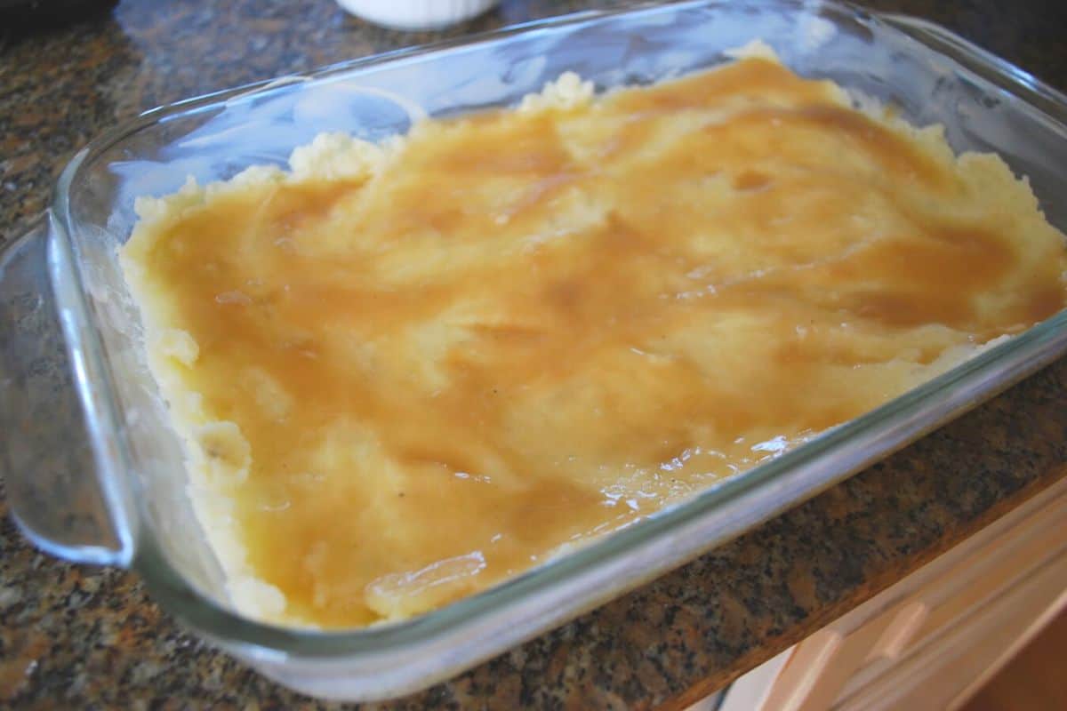 mashed potatoes with gravy in a casserole dish.