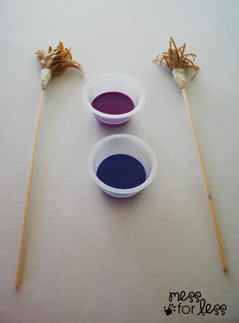  painting with rubber band paintbrushes with cups of paint