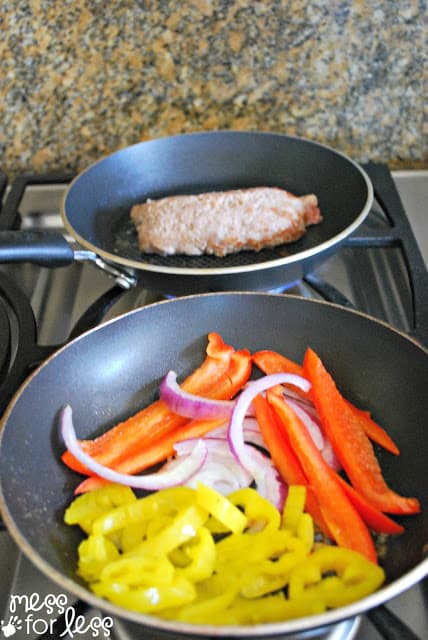 cooking peppers and sausage in frying pans