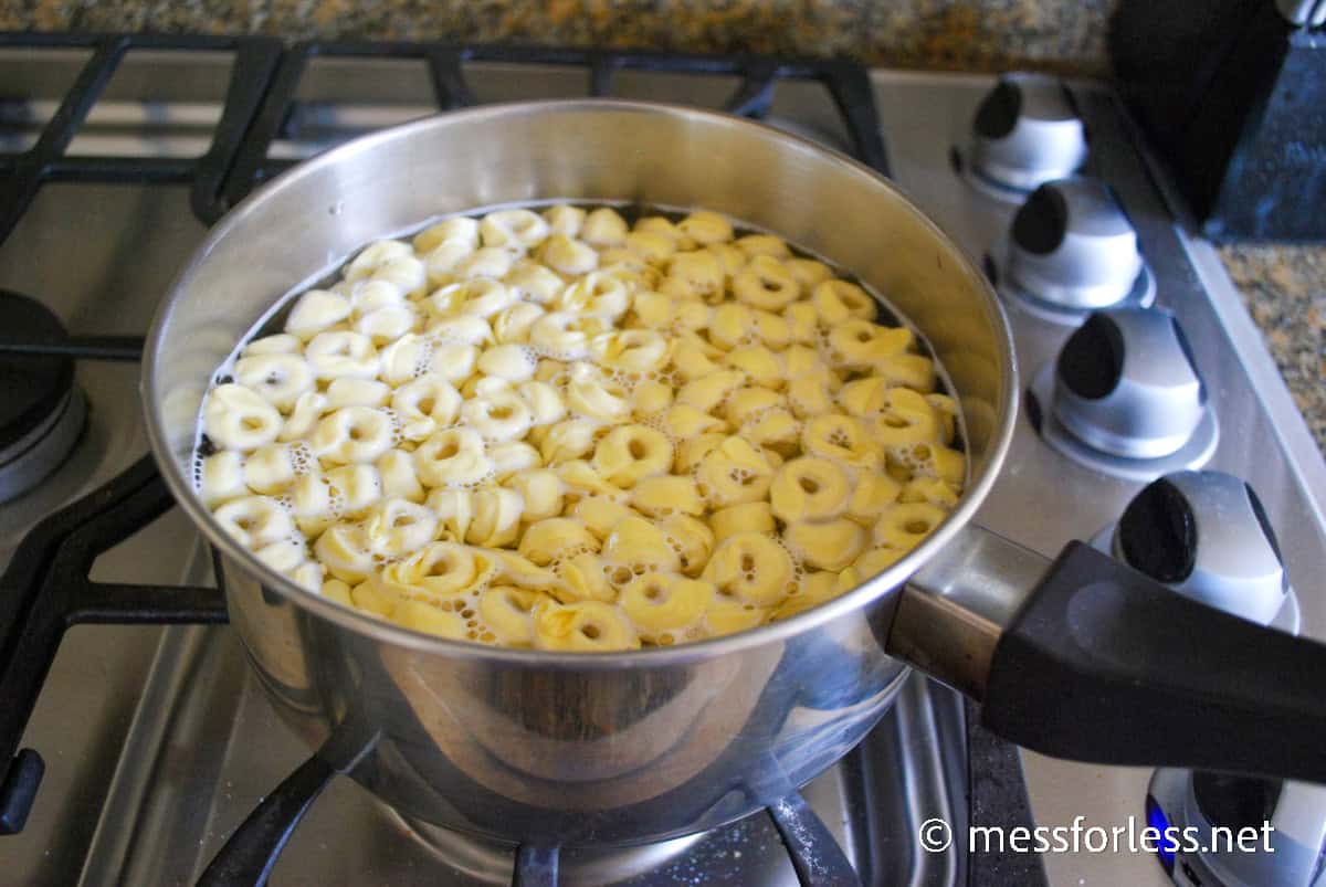Tortellini cooking in a pot on stove