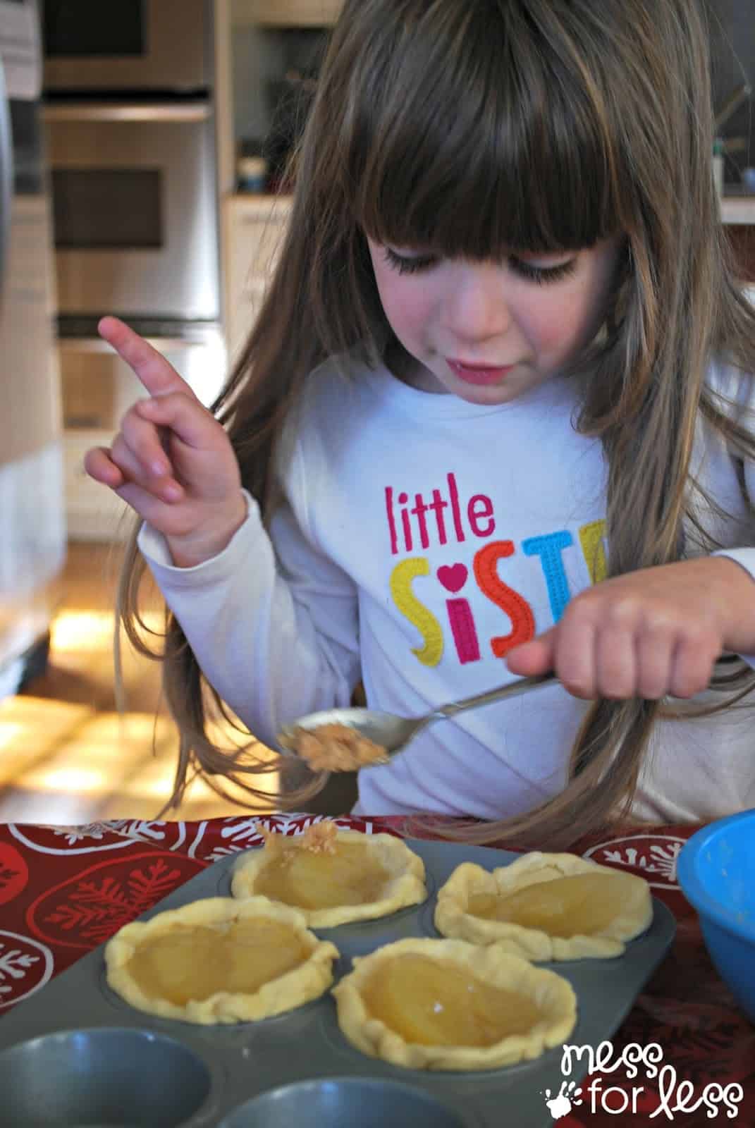 adding streusel topping child baking