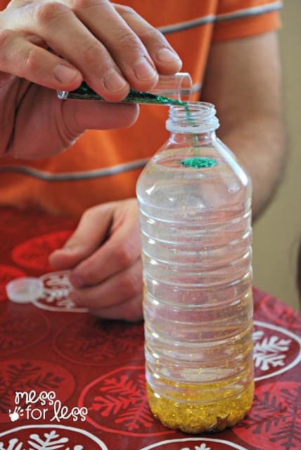 adding glitter to a sensory bottle