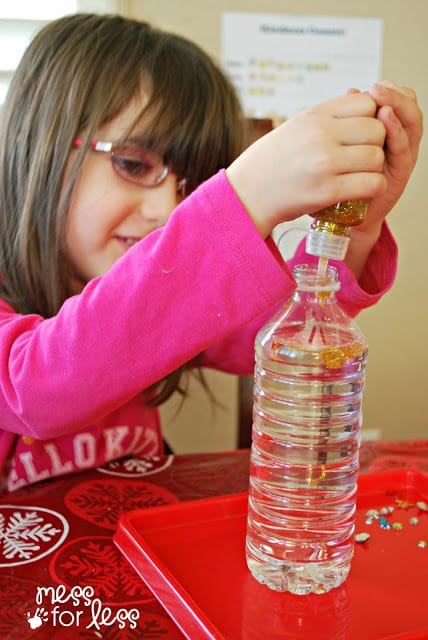 child making a glitter bottle