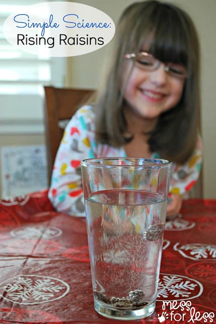 child watching raisins rise in a cup