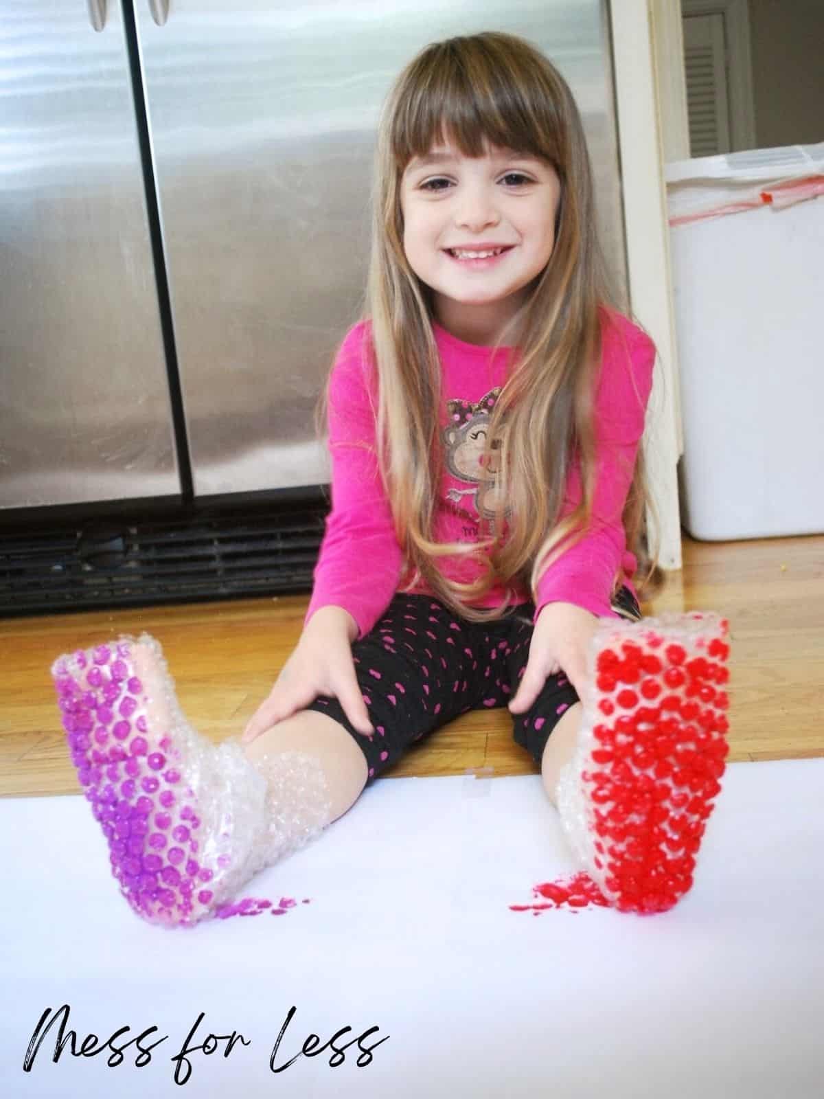 child with painted bubble wrap boots