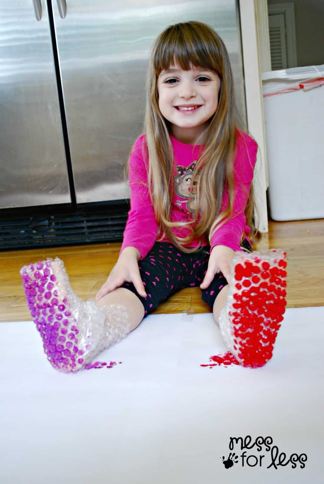 child wearing bubble wrap boots with paint on it