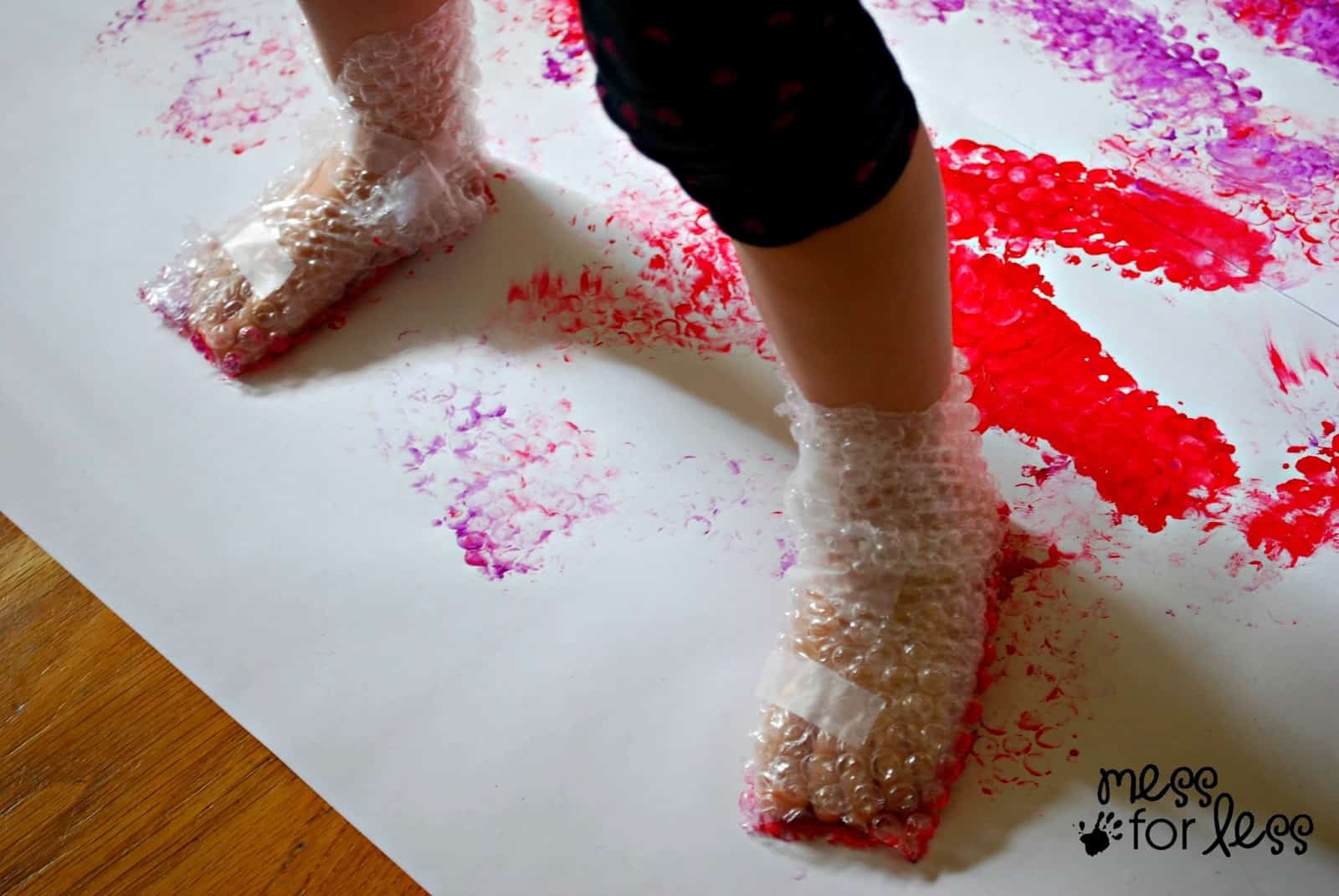 toddler painting toddler painting with bubble wrap feet