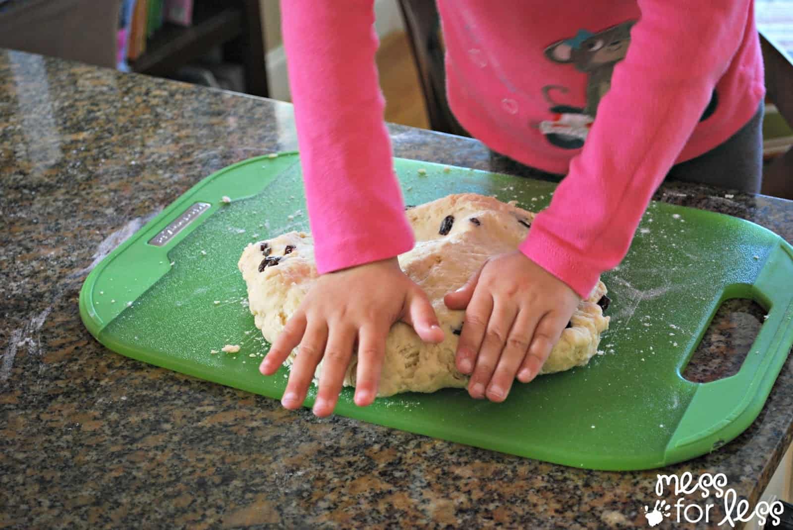 child kneading bread