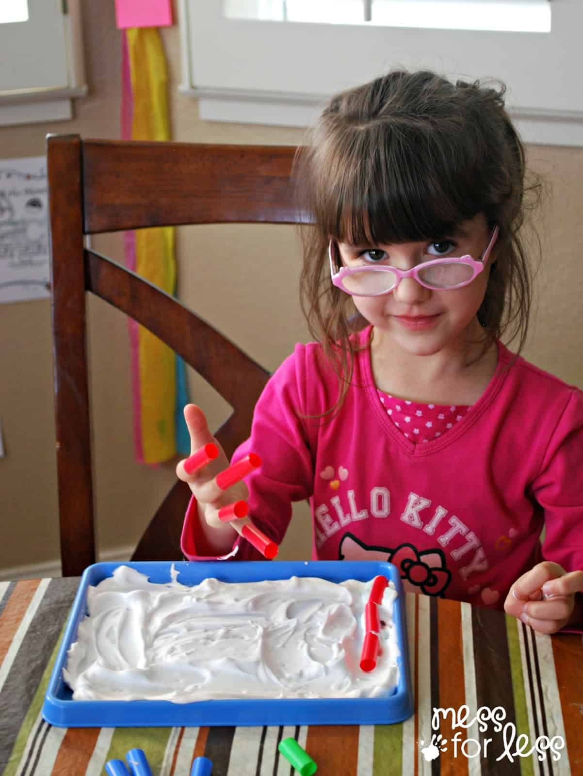 child playing with straws