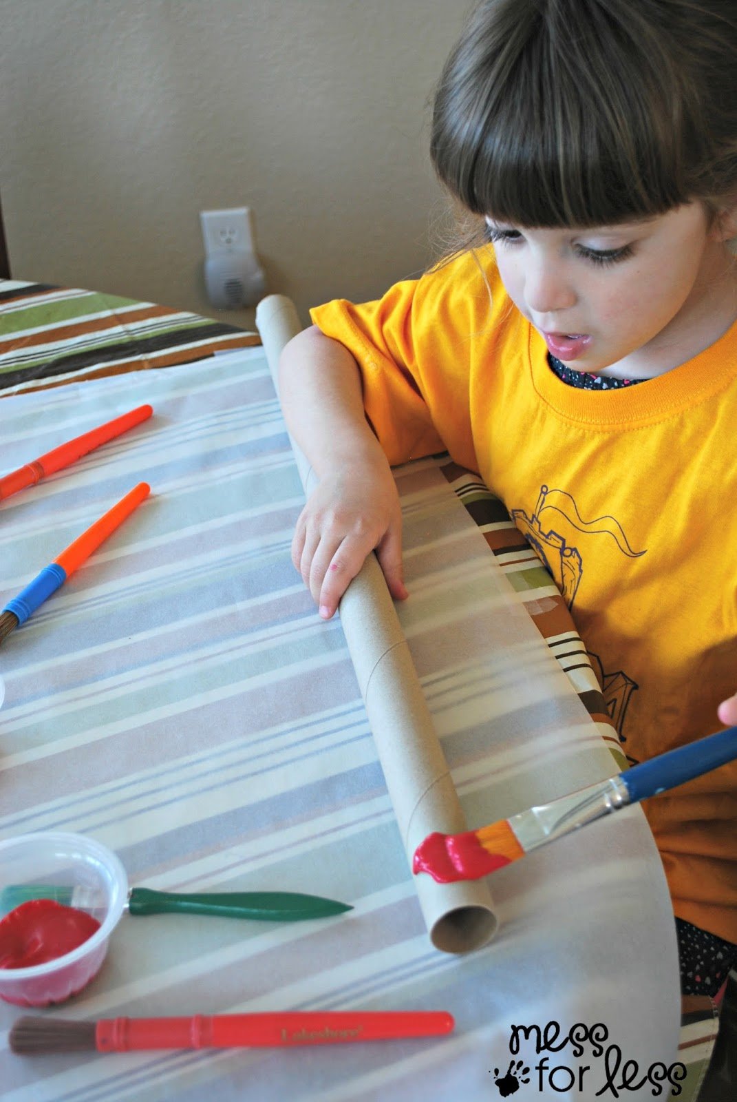 child painting a didgeridoo