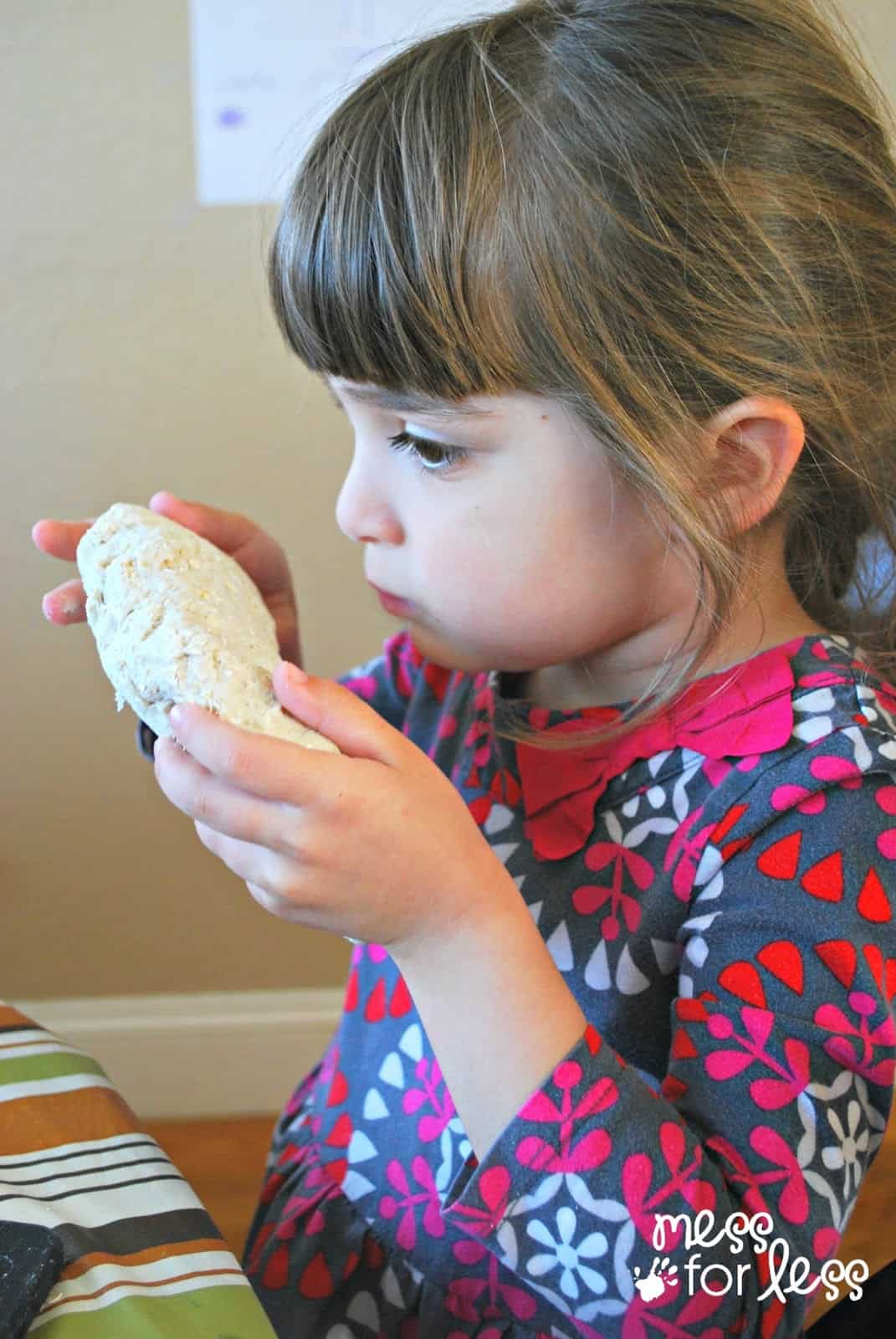 child smelling playdough