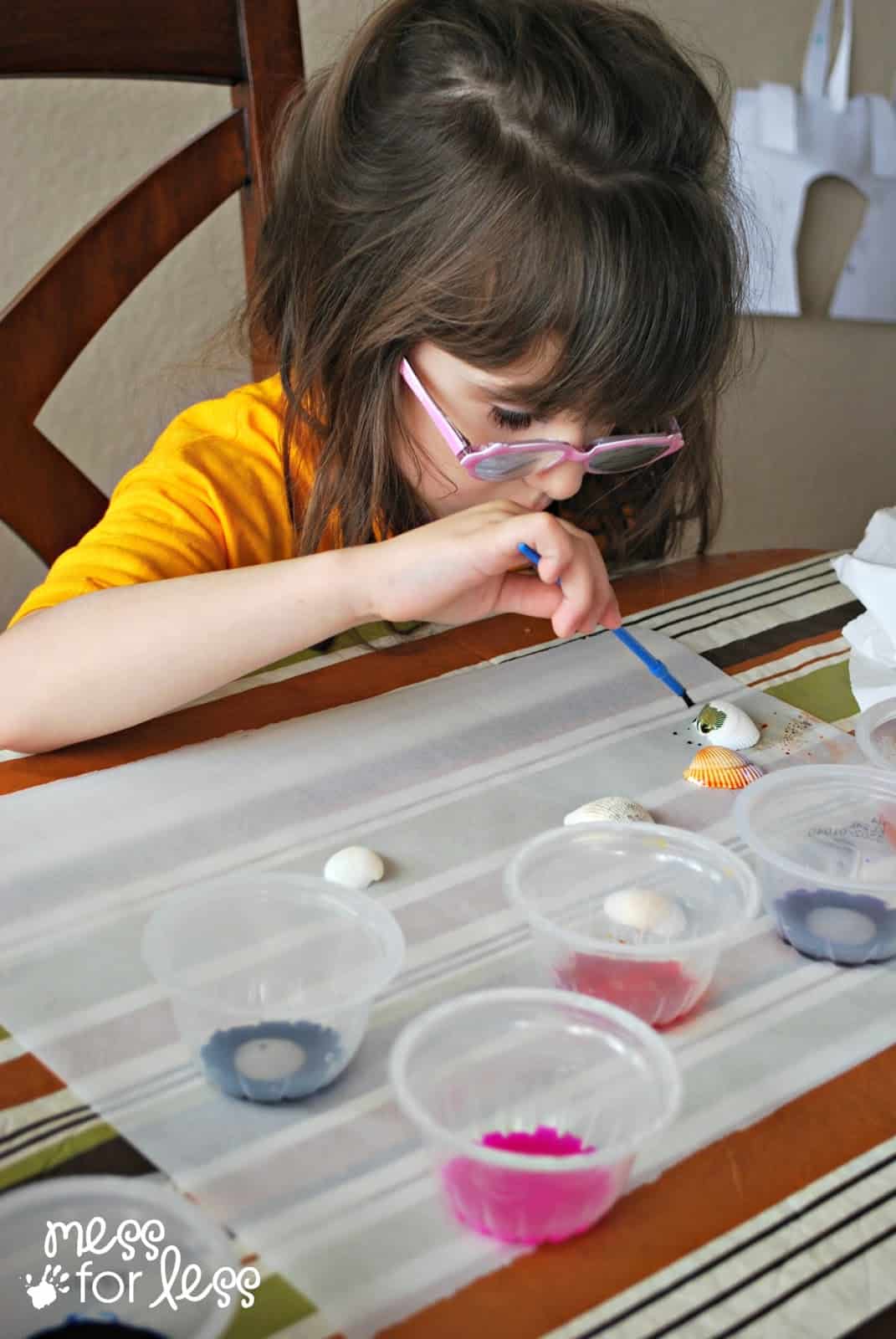 child painting seashells