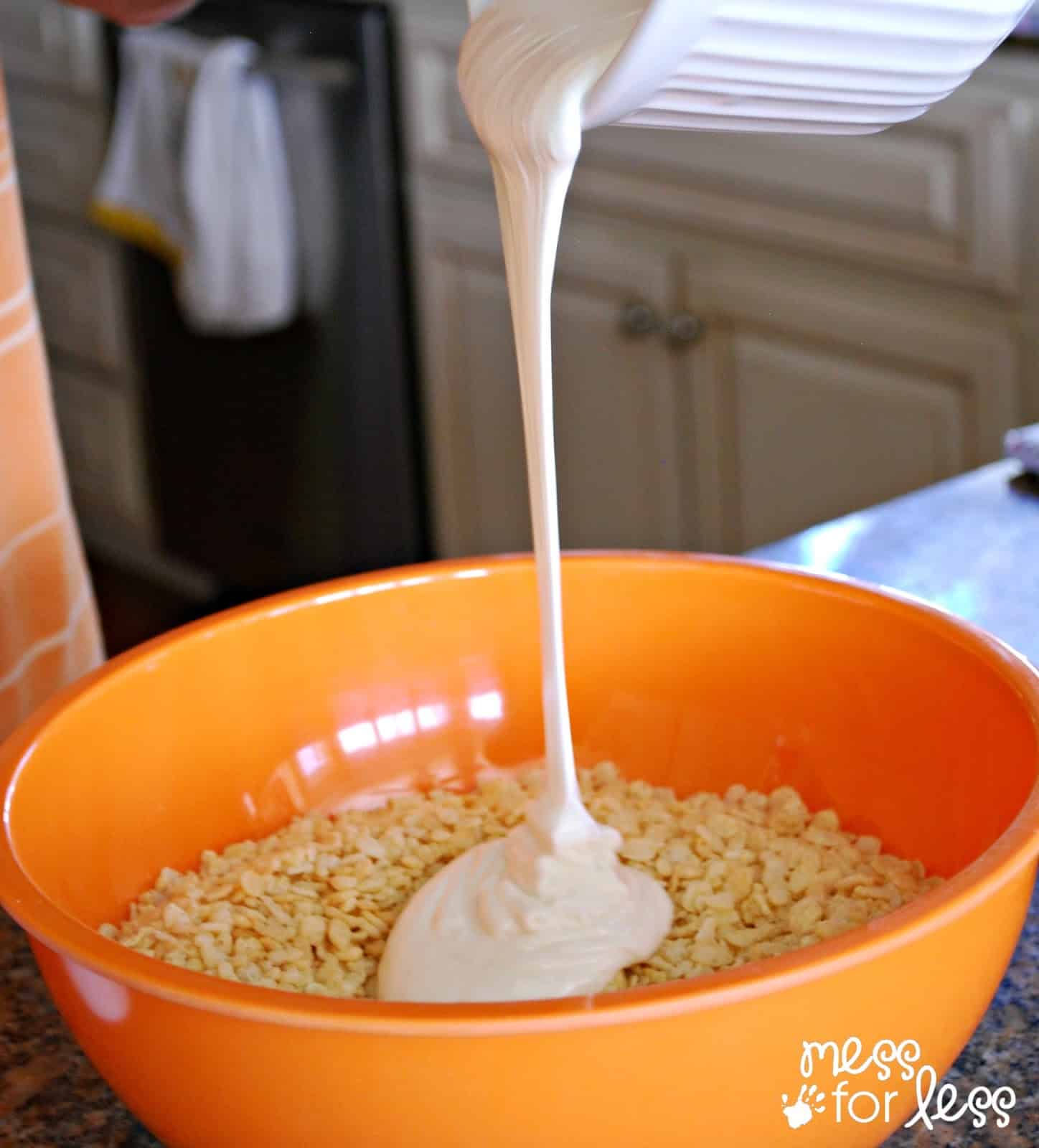 melted marshmallows being poured into rice krispies