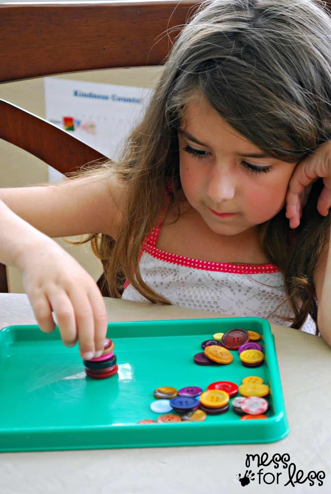 child stacking buttons