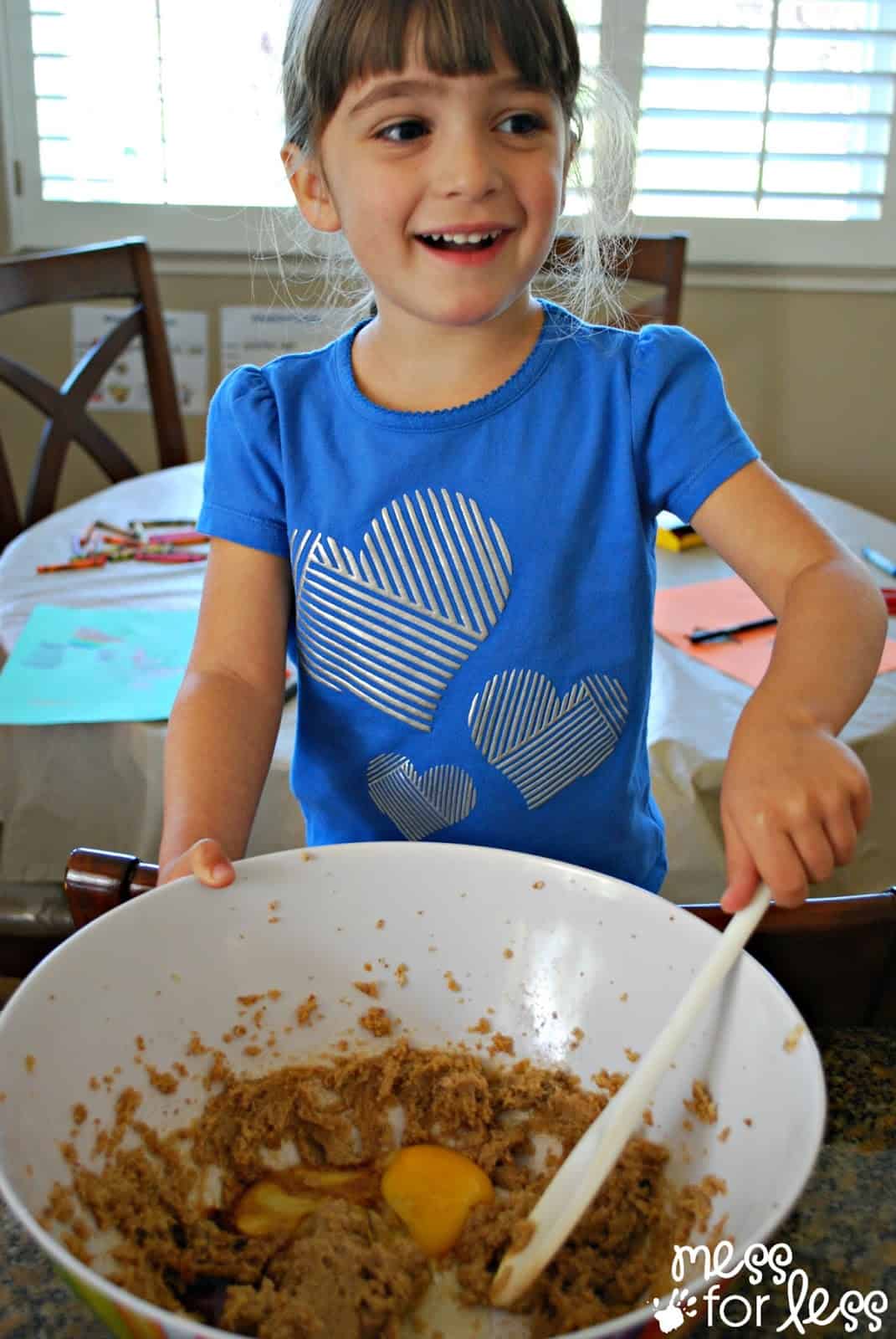 child baking white chocolate chip cookies