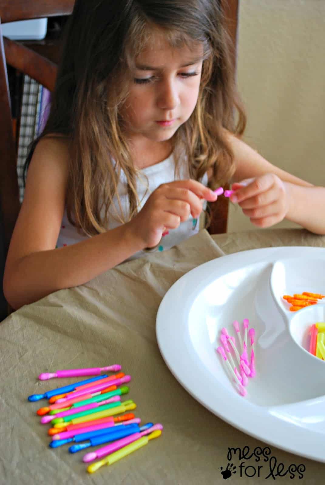 child playing with q-tips