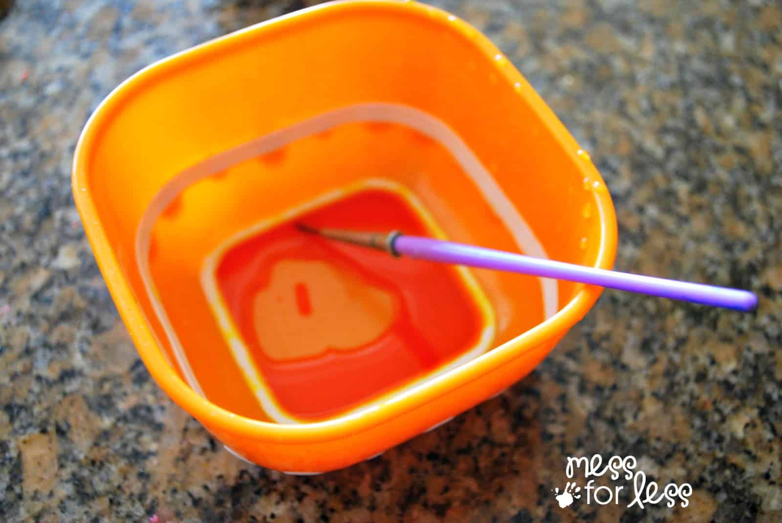 food coloring in a bowl with brush