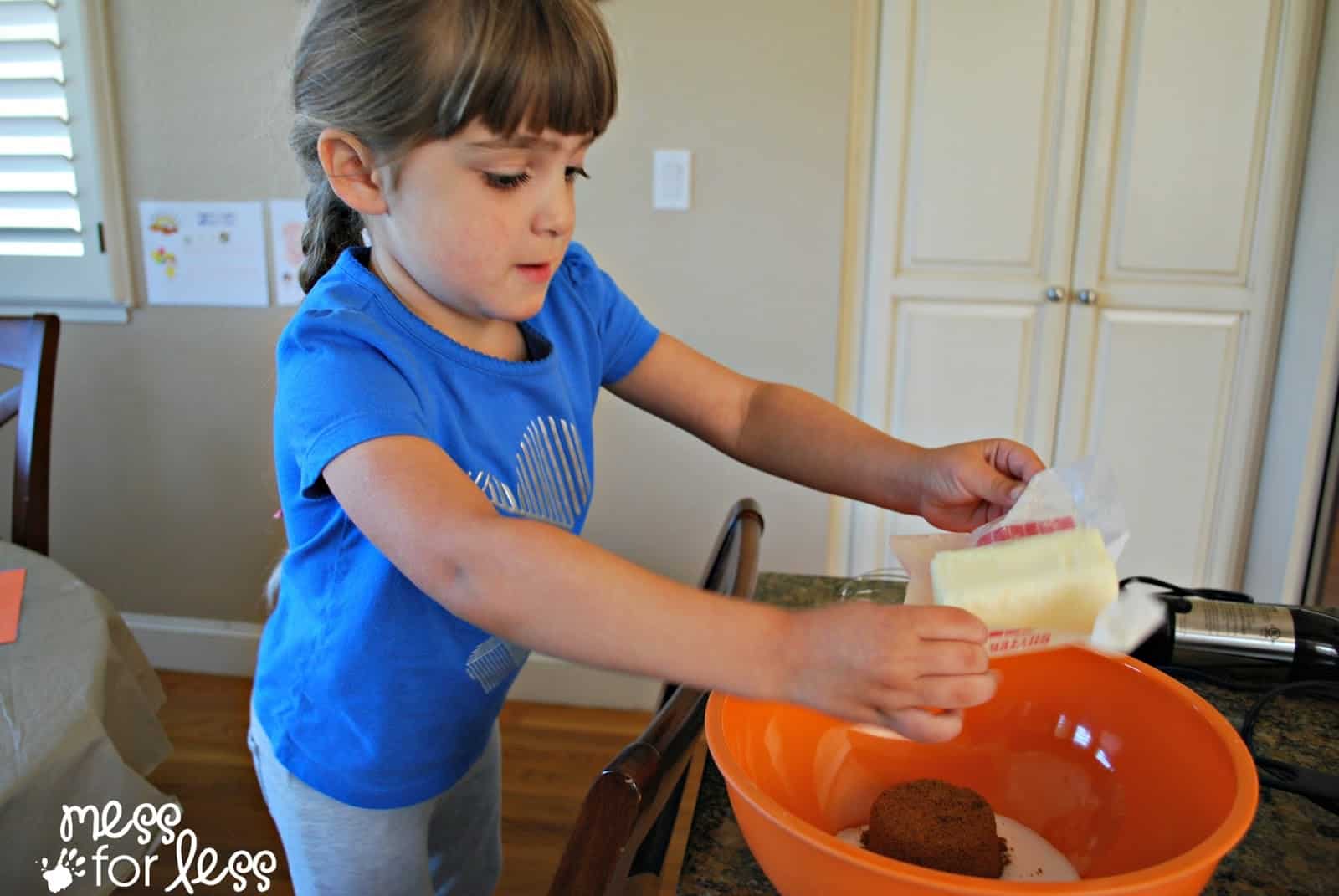 child adding butter to a bowl
