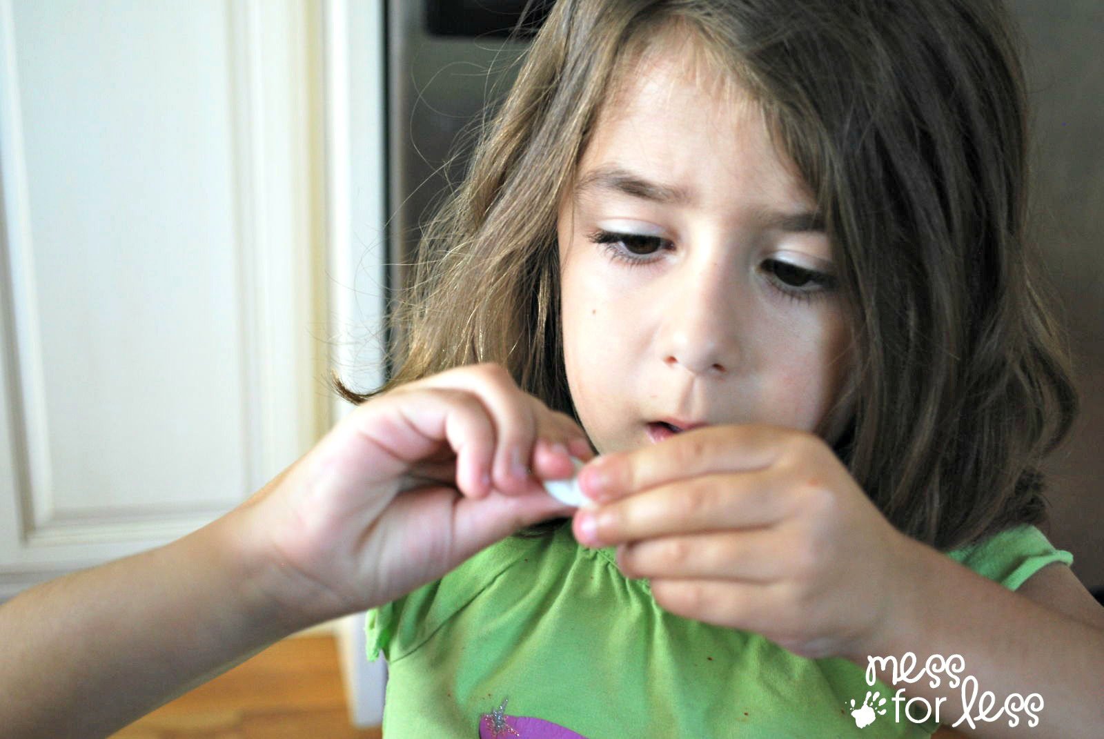 child twisting a marshmallow