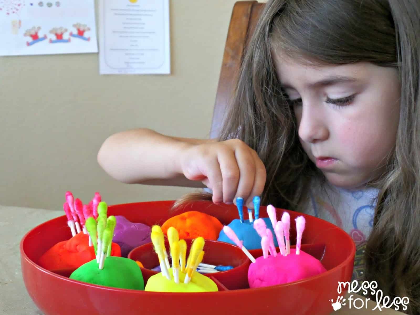 child playing with q-tips and play dough