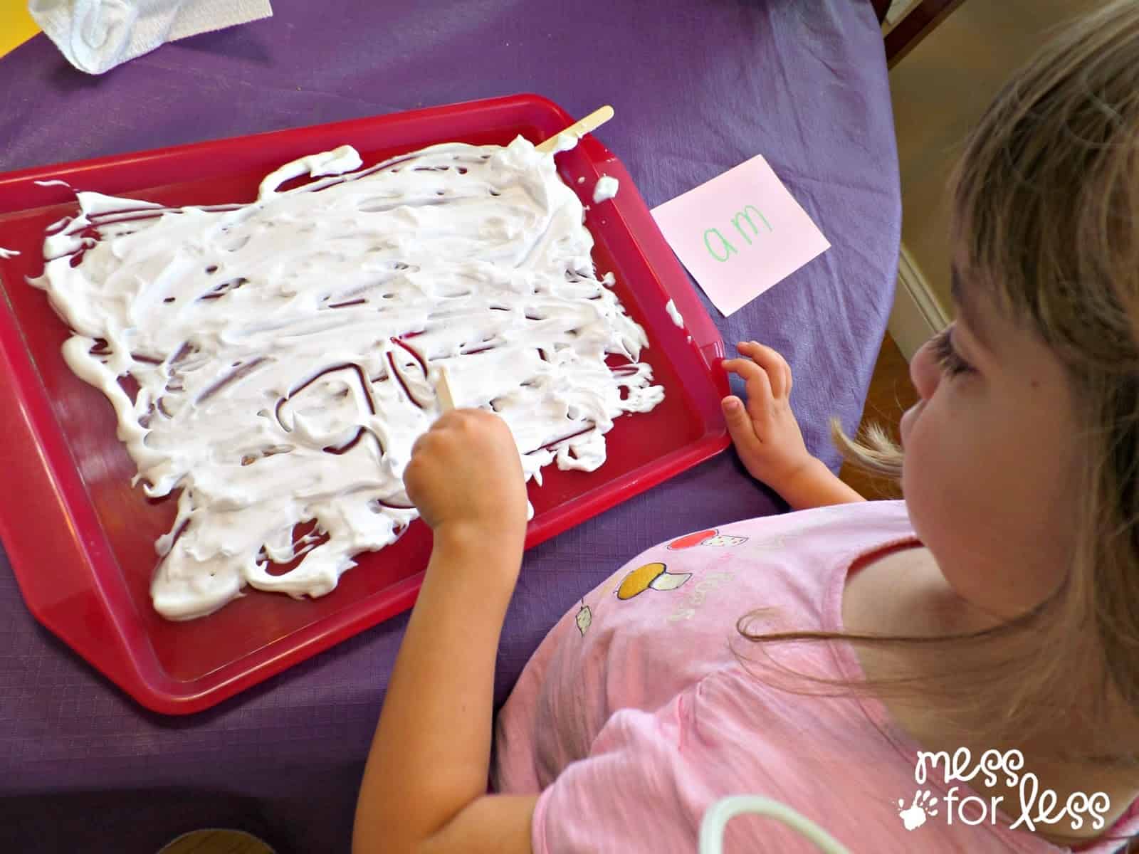 child writing in shaving cream