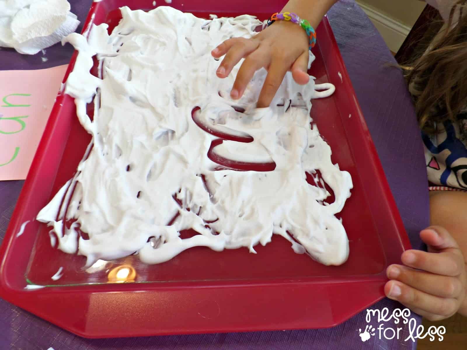 child writing in shaving cream