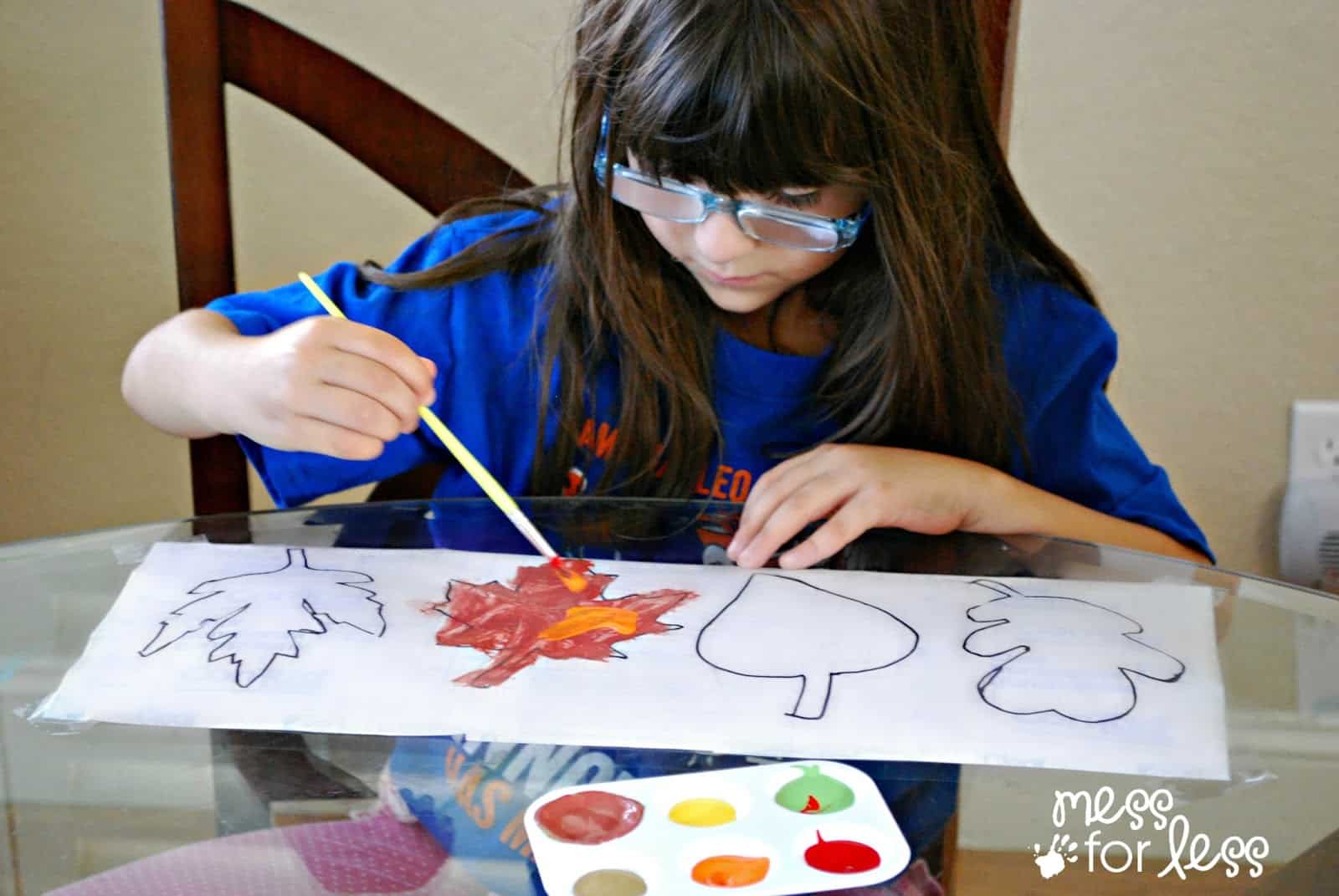 child painting fall leaves