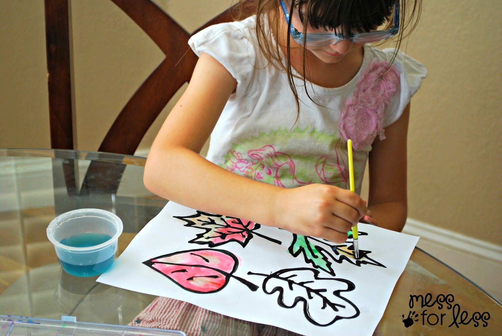 child painting paper leaves.