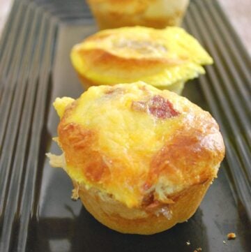 threee turkey bacon and egg muffins on plate