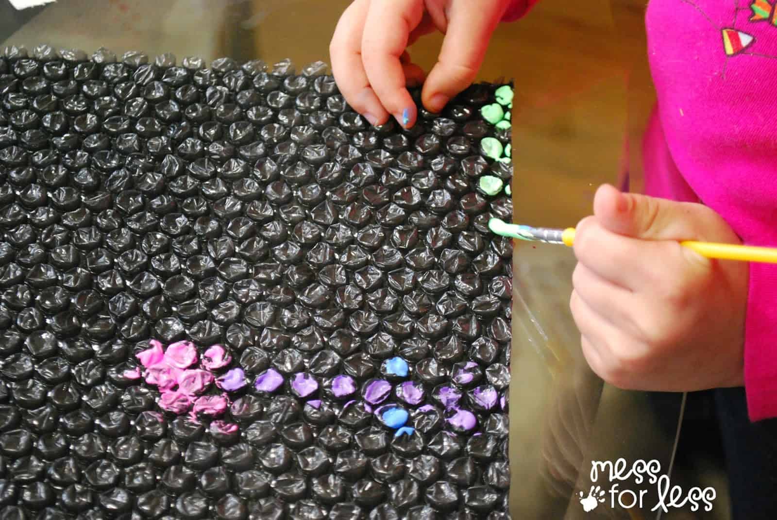 child painting on bubble wrap