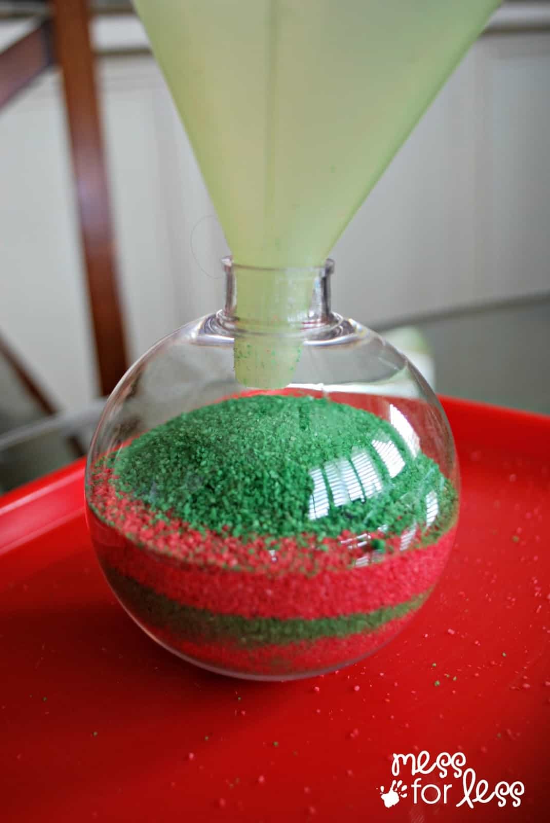 filling up christmas ornament with sand