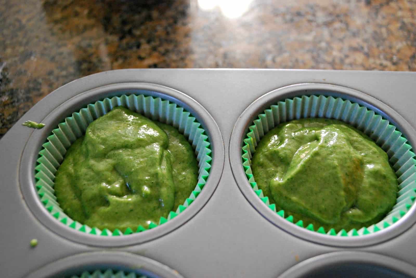 spinach muffin batter in recipe cups