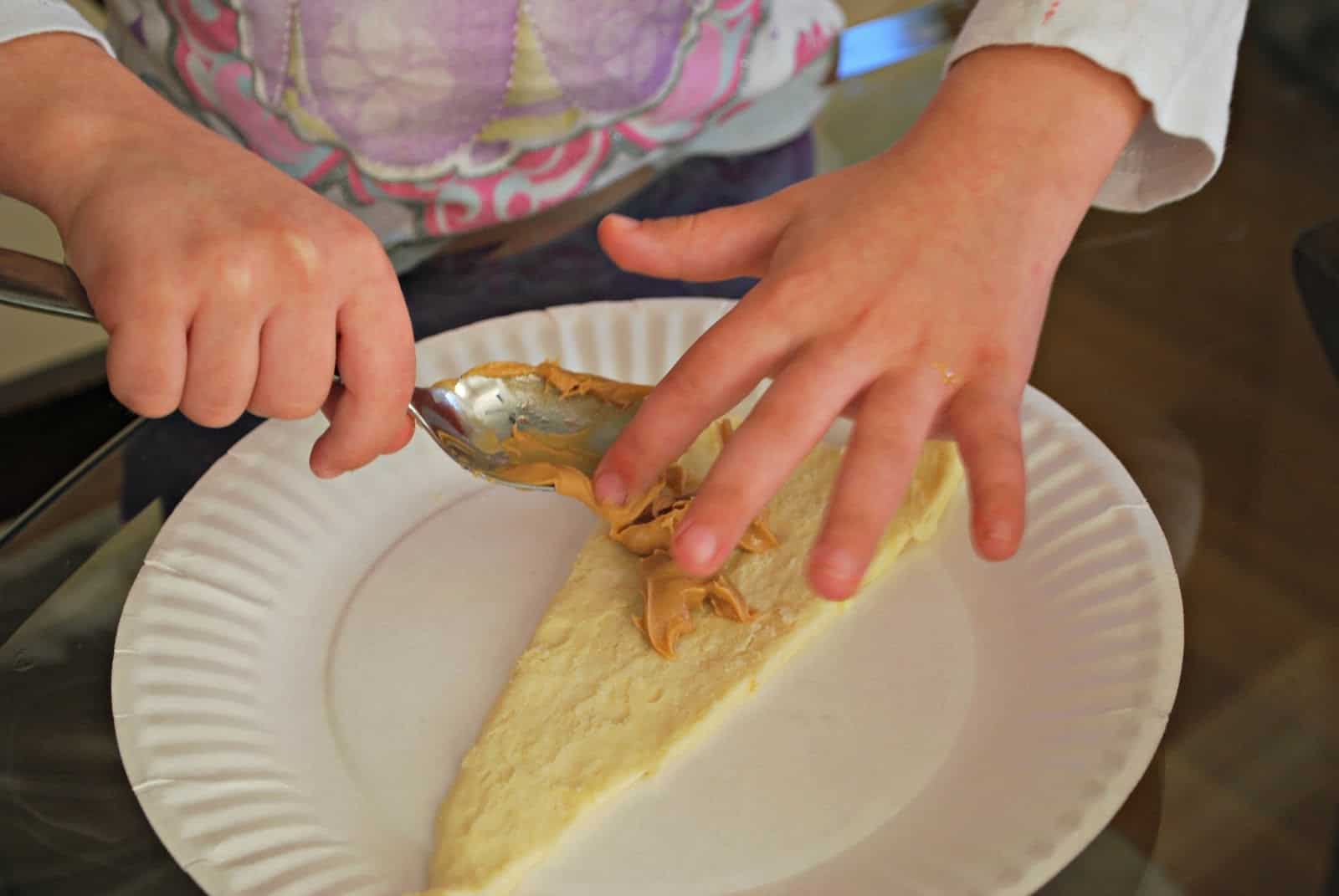 child making peanut butter and jelly crescents