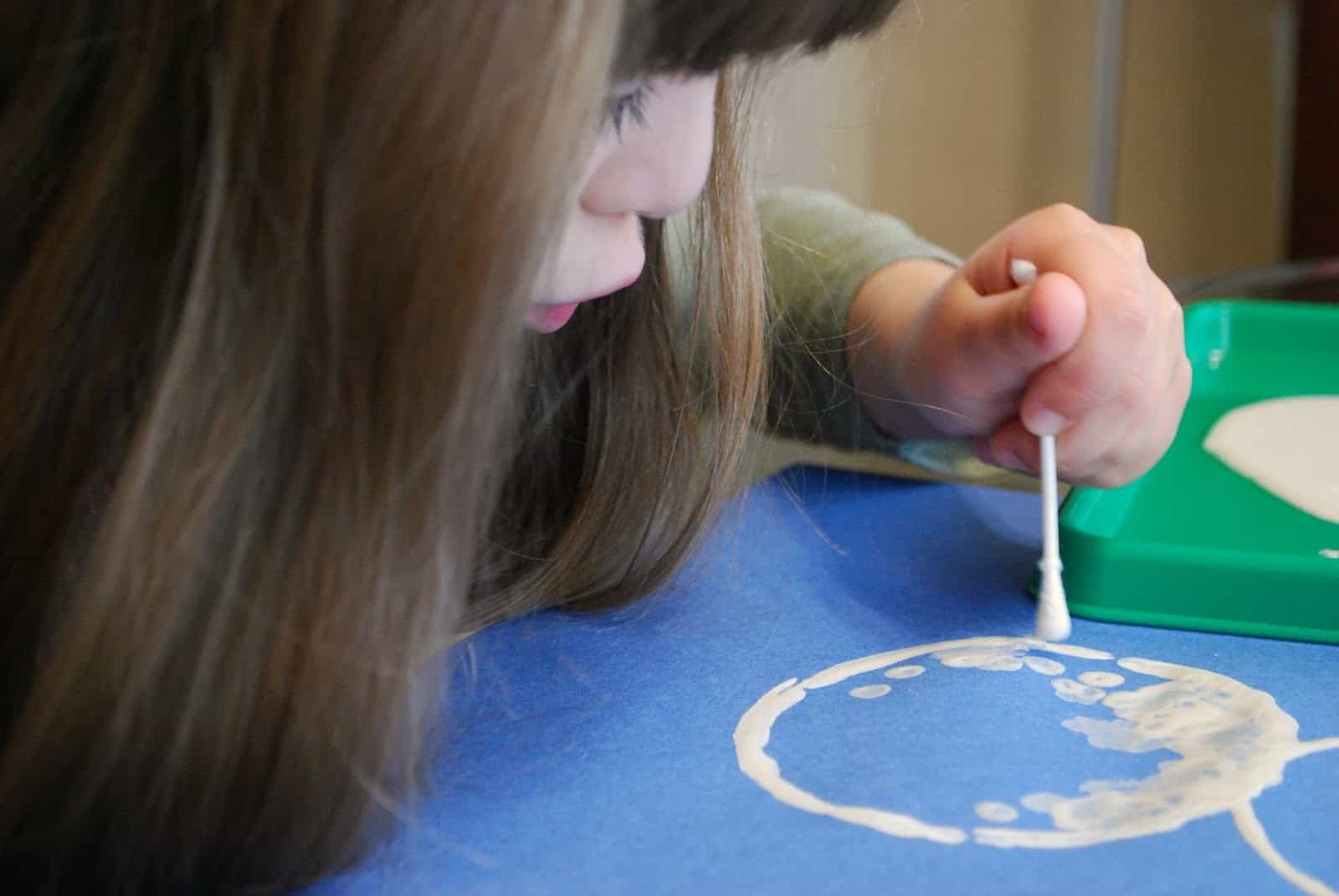 child painting a snowman