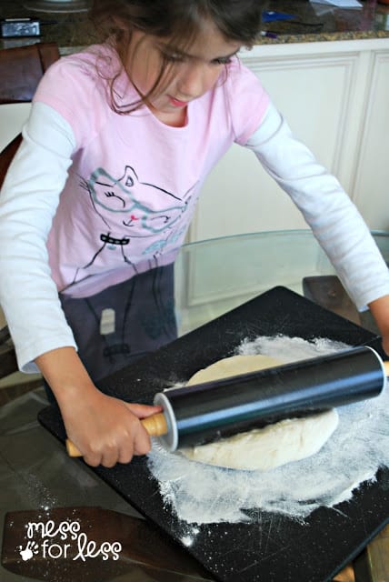 child making pizza