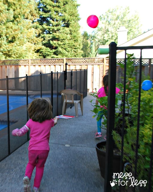 child chasing balloon