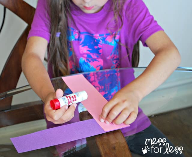 child gluing paper