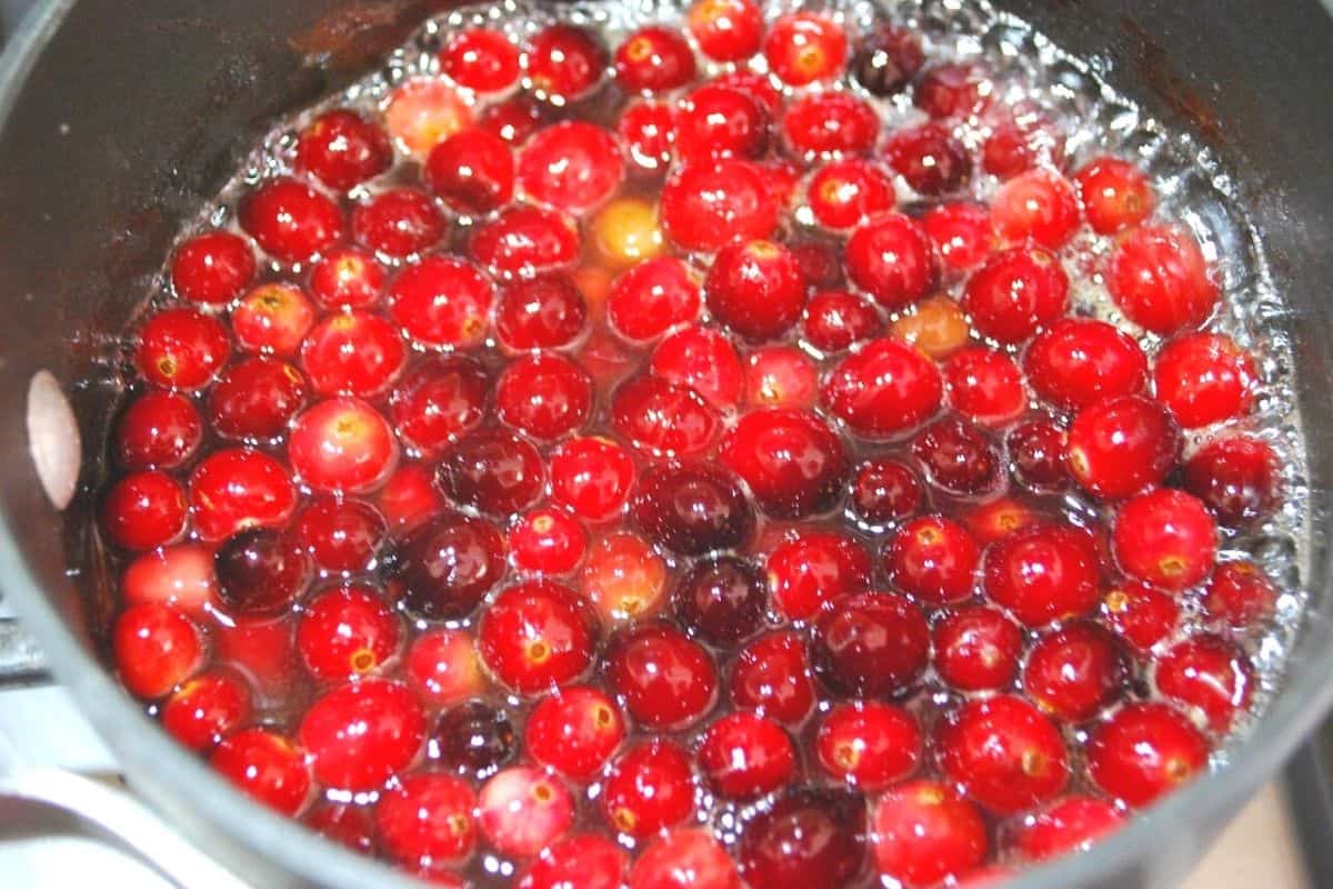 cranberries cooking in a pot.