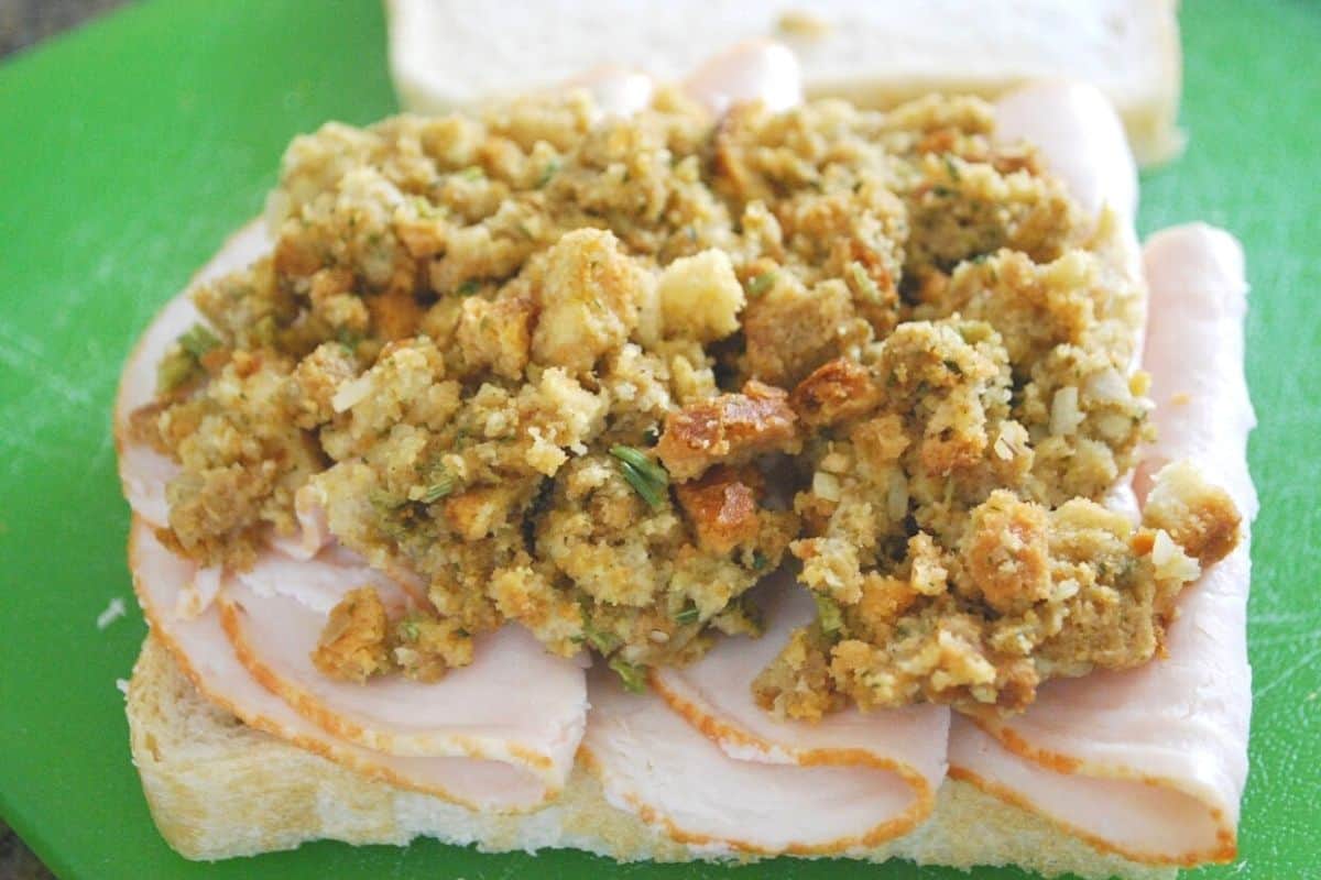sliced turkey and stuffing on a slice of bread.