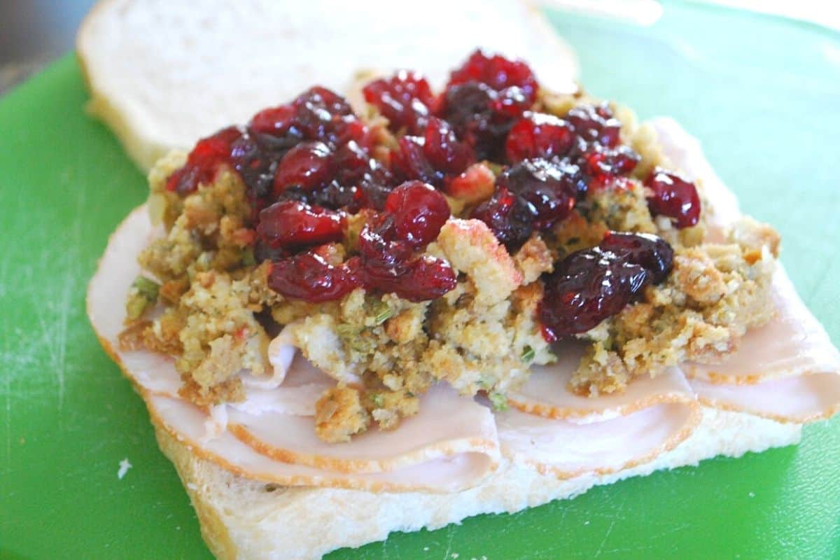 turkey stuffing and cranberry sauce on a slice of bread.