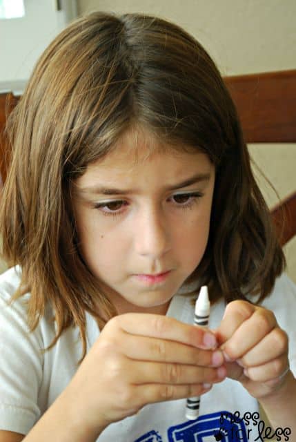 child peeling crayons