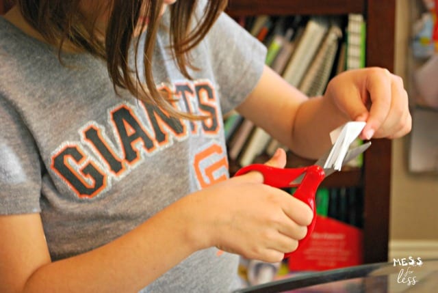 child cutting an index card change