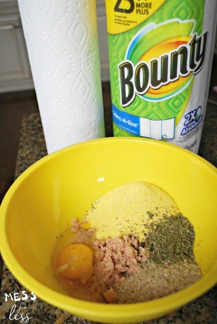 egg, tuna, catnip, cornmeal and flour in a yellow bowl