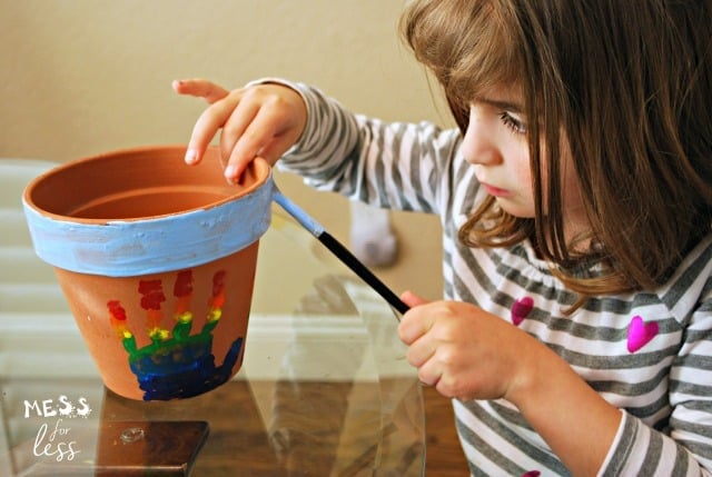 child painting pot