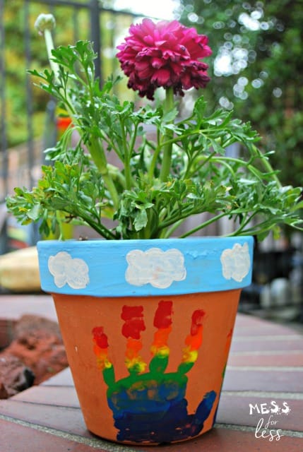 Made this rainbow hand print flower pot with the kids and it was so easy and turned out beautifully. What a great keepsake. #ad #HugTheMess 