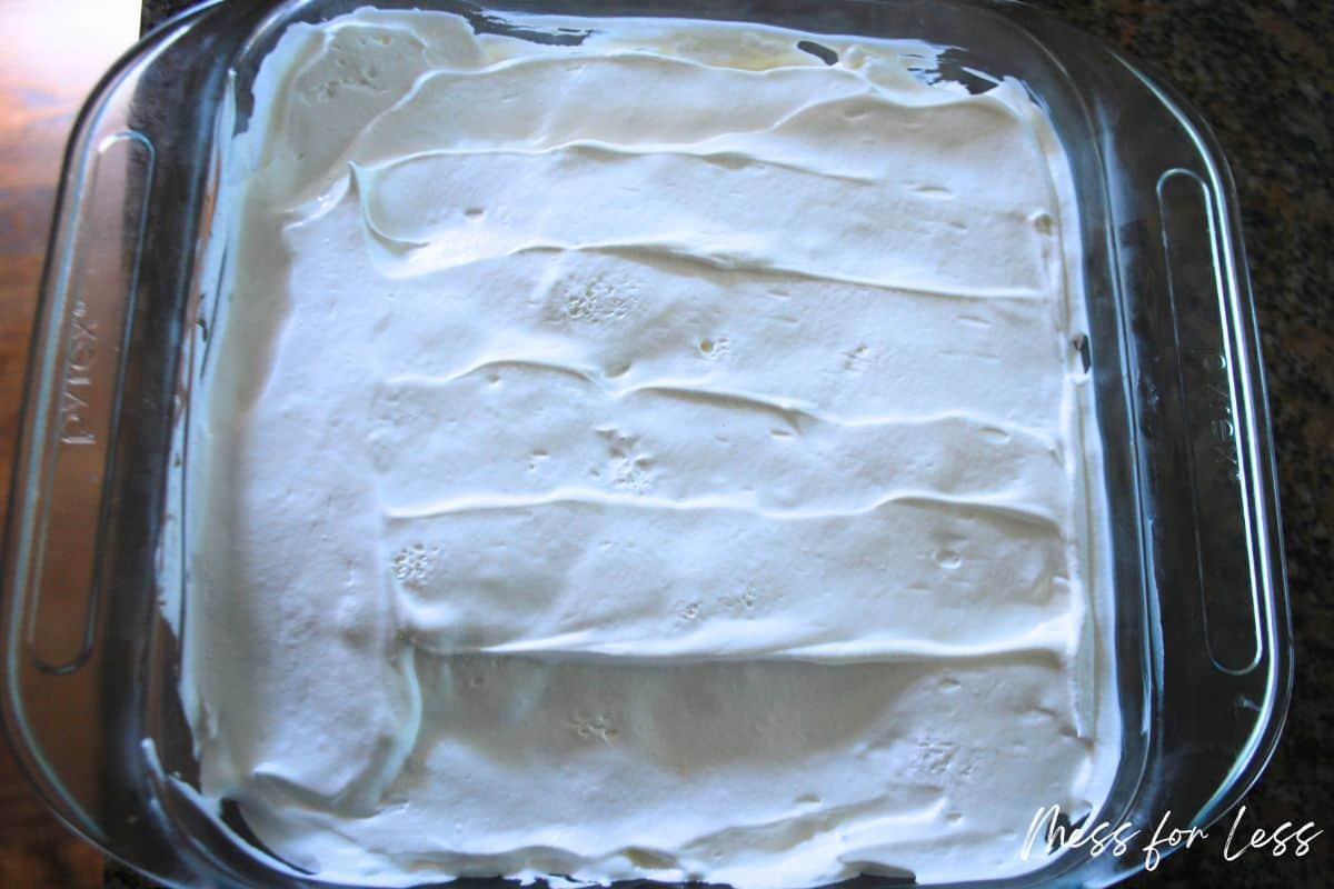 cake with whipped topping in pan