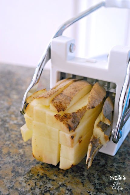 slicing potatoes with a potato slicer