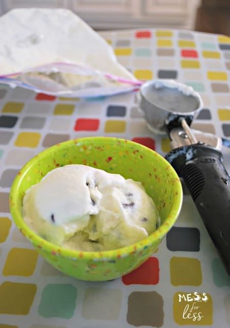 homemade ice cream in a green bowl with an ice cream scooper